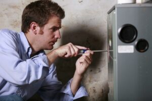 Man servicing a furnace.